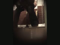 In the toilet room, a stranger white wife is seen on video urinating.